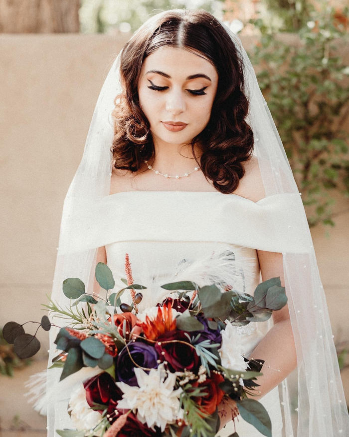 Beautiful bride with dramatic fall bouquet